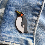 emperor penguin pin badge on denim jacket